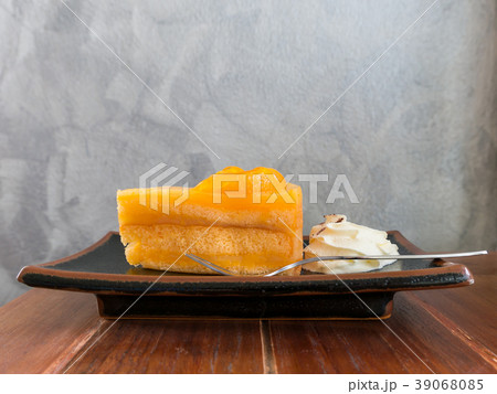 Orange cake on wooden table. Copy space 39068085