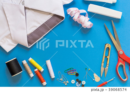Sewing accessories on blue background 39068574