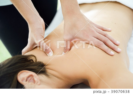 Young woman receiving a back massage in a spa center. Young woman receiving a back massage in a spa center. 39070638