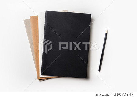 Top view of notebook and color pencil on white 39073347