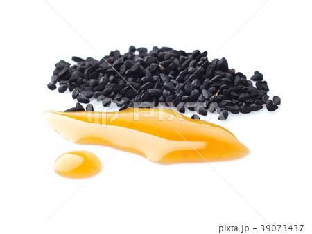 Black cumin oil with seeds on white background 39073437