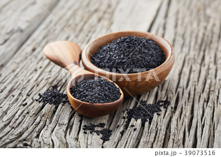 Black cumin on wooden background 39073516