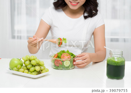 Young asian woman eating fresh salad at home 39079755