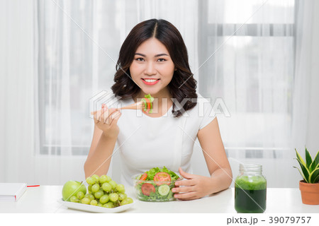 Young asian woman eating fresh salad at home 39079757