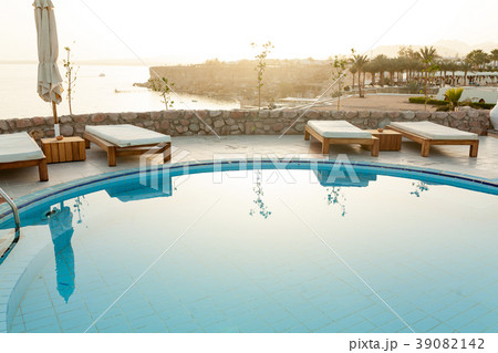 Swimming pool with chaise lounge and sunshade 39082142