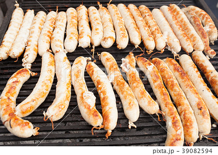 BBQ with fiery sausages on the grill BBQ with fiery sausages on the grill 39082594