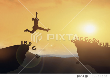 Silhouette of people jumping from cliff to other b 39082688