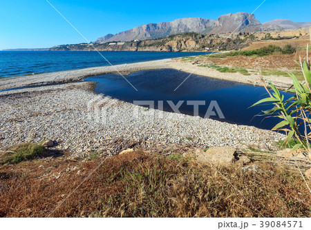 Small river flows into the sea on pebble beach 39084571
