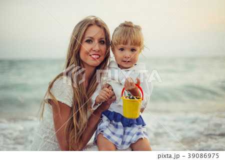 Mom with daughter near the sea close up Mom with daughter near the sea close up 39086975