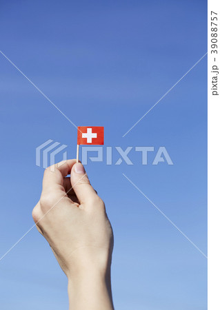 Woman holding Swiss flag in hand 39088757