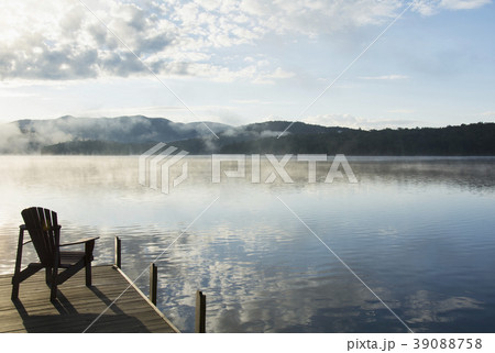 USA, New York State, Adirondack chair on jetty by Lake Placid 39088758