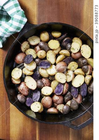 Close up of roasted potatoes in skillet on table Close up of roasted potatoes in skillet on table 39088773