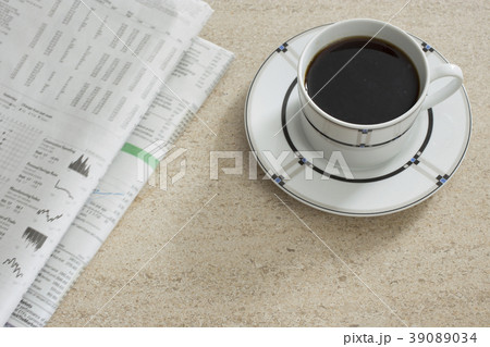 Newspaper and coffee on table 39089034