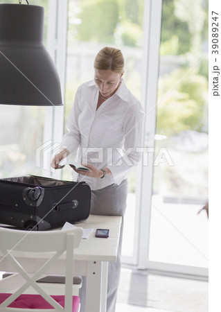 Woman packing suitcase for business travel 39089247