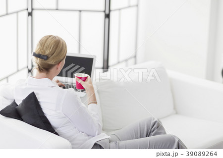 Woman using laptop in living room 39089264
