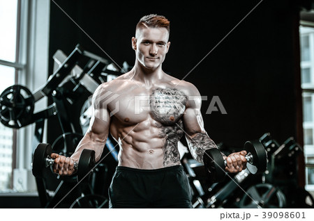 Handsome model young man working out in gym 39098601