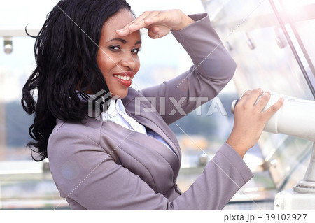 African woman looking through binoculars African woman looking through binoculars 39102927