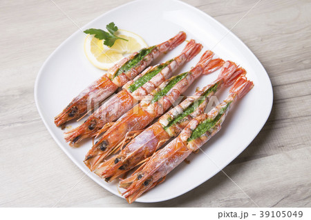 Baked langoustines on a white plate. Baked langoustines on a white plate. 39105049