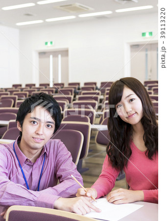 教室で女子生徒に教える若い男性 39113220