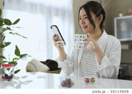 ビューティー　リビングでスマホを見る　若い女性 39114608