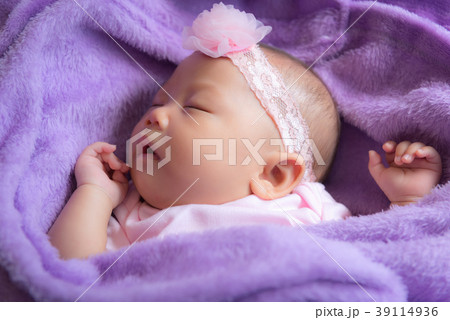 Baby is asleep on the purple bed Baby is asleep on the purple bed 39114936