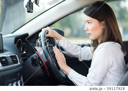 Woman pressing horn while driving a car with angry 39117928