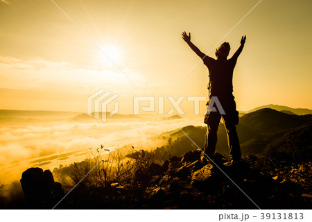 Silhouette man standing on top of the mountain 39131813