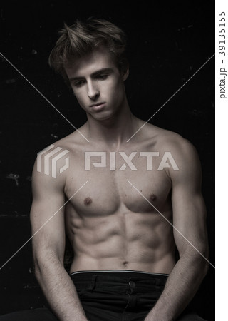 Young Handsome man portrait at dark background Young Handsome man portrait at dark background 39135155