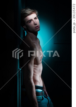 Young Handsome man portrait at dark background Young Handsome man portrait at dark background 39135472