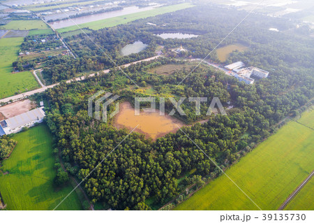 Beautiful aerial view of yellow pond surrounded by turquoise tre 39135730
