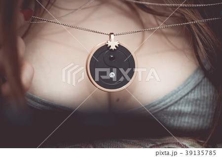Chakra medallion hanging on the woman's neckline 39135785
