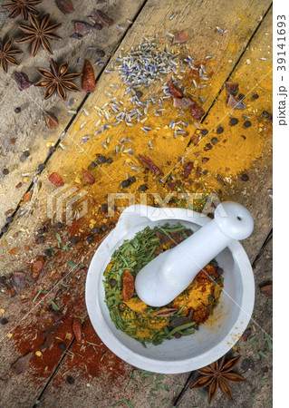 Herbs and spices and a mortar and pestle 39141693