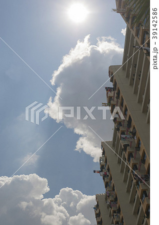A tall residential housing against a sunny sky A tall residential housing against a sunny sky 39142586