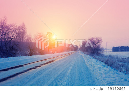Rural winter landscape. Sunrise over snowy road 39150865