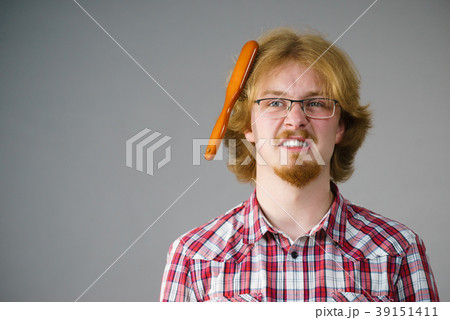 Man having problem with brushing hair Man having problem with brushing hair 39151411