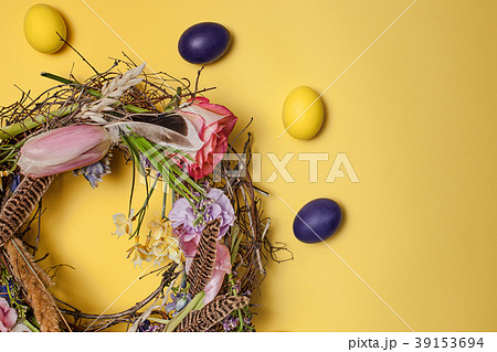 Easter card. Painted Easter eggs in nest on yellow Easter card. Painted Easter eggs in nest on yellow 39153694