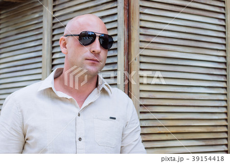 bald man at wood background at spring time. shirt. 39154418