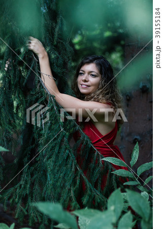 girl in red dree look from fir tree 39155184