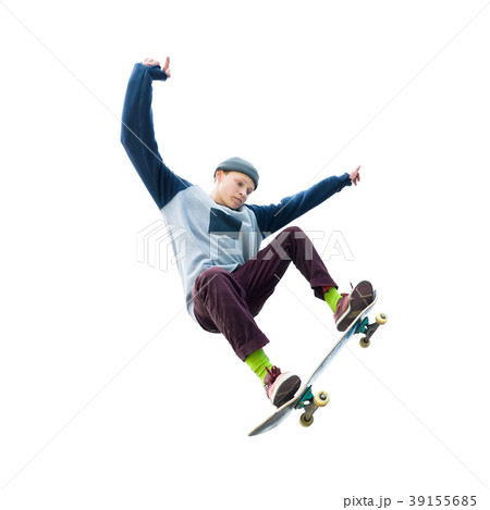 A teenager skateboarder jumps an ollie on an 39155685