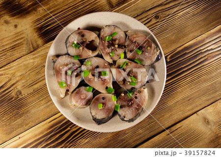 Sliced mackerel with spices on wooden table Sliced mackerel with spices on wooden table 39157824
