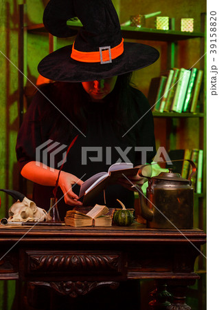 Photo of witch with spell book 39158820