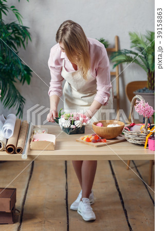Portrait woman of florist composing bouquet of Portrait woman of florist composing bouquet of 39158863
