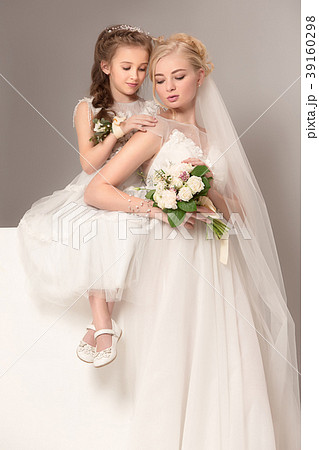 Little pretty girls with flowers dressed in 39160298