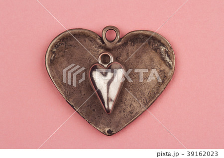 two vintage heart shaped jewels on top of other 39162023