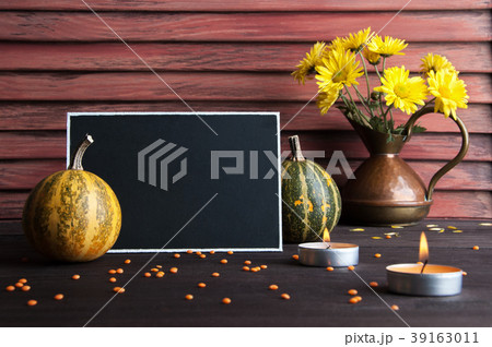 Black board, pumpkin and copper jug 39163011