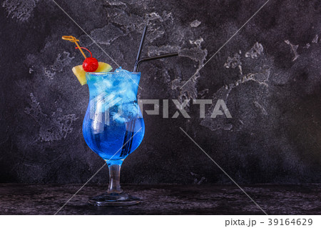 Blue Curacao cocktail decorated with fruit. 39164629