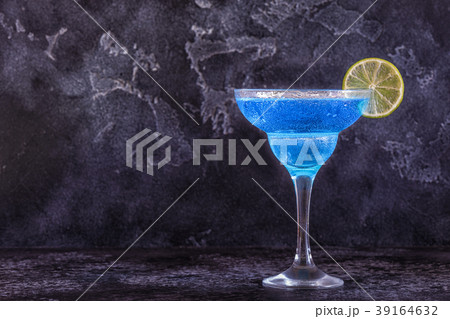 Blue Curacao cocktail decorated with fruit. 39164632