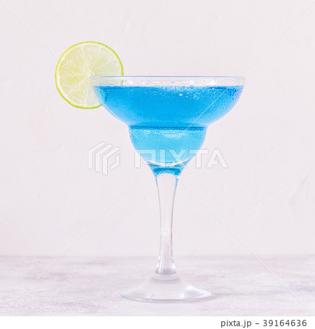 Blue Curacao cocktail decorated with fruit. 39164636