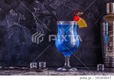 Blue Curacao cocktail decorated with fruit. 39164647