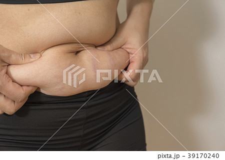 ダイエット前の女性お腹の肉をつまむ右斜め ダイエット前の女性お腹の肉をつまむ右斜め 39170240